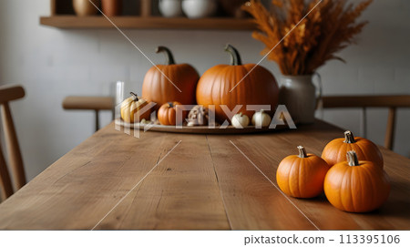 Wooden table and pumpkins, rustic kitchen interior with autumn fall decorations, blurred background.Selective focus and copy space. 113395106