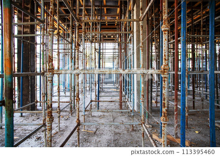 Prepared scaffolding for formwork to cover the 2nd floor for pouring reinforced concrete into a building under construction. Prepared scaffolding for formwork to cover the 2nd floor for pouring reinforced concrete into a building under construction. 113395460
