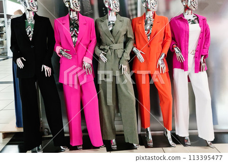 Colorful women's clothing in a boutique is worn on mannequins. Colorful women's clothing in a boutique is worn on mannequins. 113395477