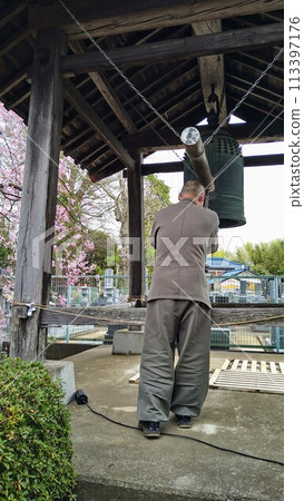 A monk ringing the bell to announce the time of day A monk ringing the bell to announce the time of day 113397176