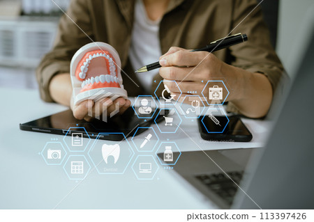 Dentist working tooth model at office in the morning at the desk. 113397426