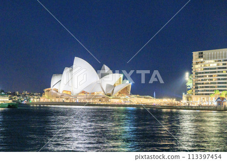 Illuminated Opera House at night seen from the sea Illuminated Opera House at night seen from the sea 113397454