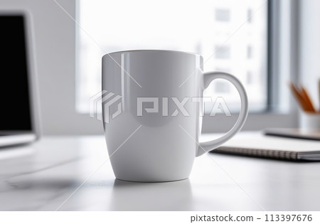 Mug Mock-Up. Blank white 11 oz ceramic cup is on a desk, office interior blurred background. Great for overlaying your custom quotes and designs for selling mugs. Notebooks on wooden table indoors. 113397676