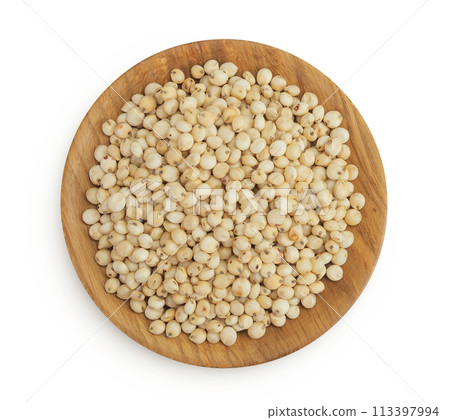 Sorghum seeds in wooden bowl isolated on white background. Top view. Flat lay. 113397994