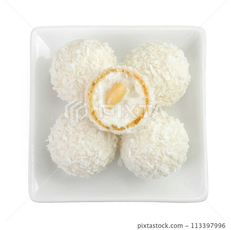 round candy raffaello with coconut flakes and nut in ceramic bowl isolated on white background. Top view. Flat lay. 113397996