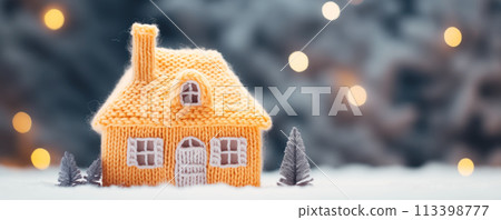 Knitted house standing on snow on beautiful snowy background, Heating concept. 113398777