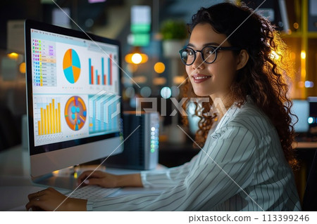 Business manager utilizes a desktop computer to analyze statistics, commerce data, and marketing plans. 113399246