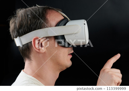 Person using virtual reality goggles Person using virtual reality goggles 113399999