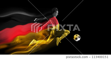 Concentrated young man, soccer athlete training, playing football on black background with flag of Germany element 113400151