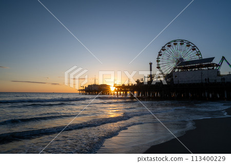 Ferris wheel dyed at sunset Ferris wheel dyed at sunset 113400229
