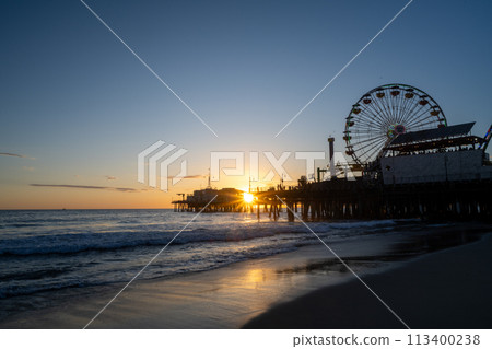 Ferris wheel dyed at sunset 113400238