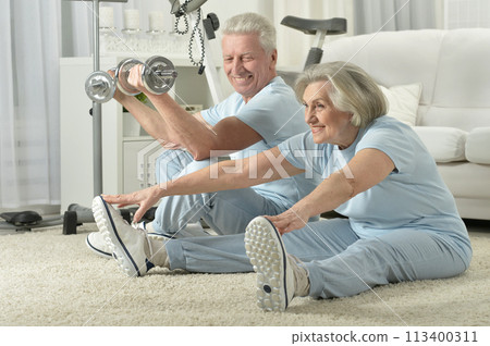 Portrait of happy sporty senior couple exercising 113400311