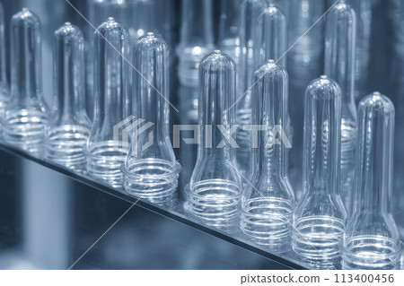 Close up scene of group of preform shape of PET bottle products. 113400456