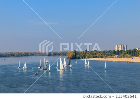 Yachts at sailing regatta on the Dnieper river in Kremenchug, Ukraine 113402641
