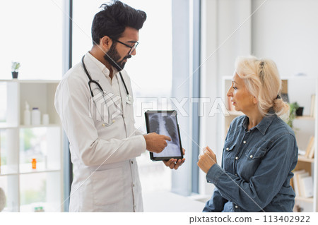 Anxious woman dressed carefully listening to physician's instructions. 113402922