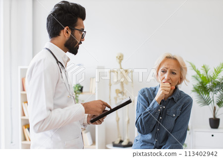 Bearded specialist writing instruction for taking medication correctly. Bearded specialist writing instruction for taking medication correctly. 113402942