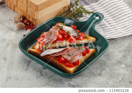 Sandwich with tomato and anchovy 113403226