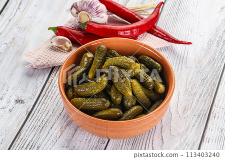 Marinated small cucumbers in the bowl 113403240