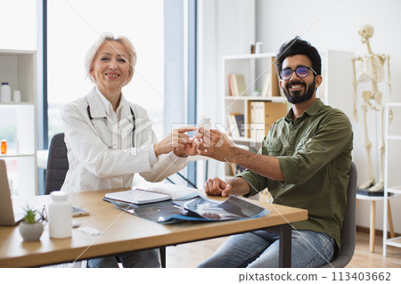 Happy man listening attentively to recommendations regarding medical history. 113403662