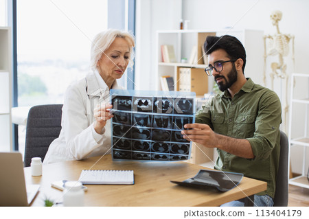Anxious man carefully listening to physician's instructions. Anxious man carefully listening to physician's instructions. 113404179