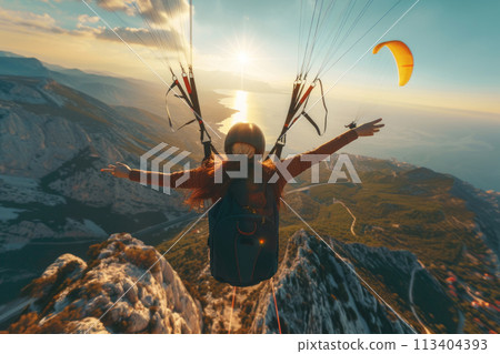 Happy paragliders flying on a paraglider, aerial view of flying paragliders Happy paragliders flying on a paraglider, aerial view of flying paragliders 113404393