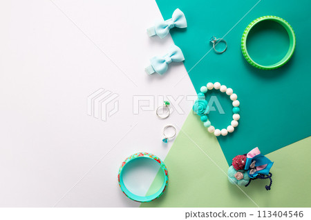 Little girls accessories on a white and green background, flat lay Little girls accessories on a white and green background, flat lay 113404546