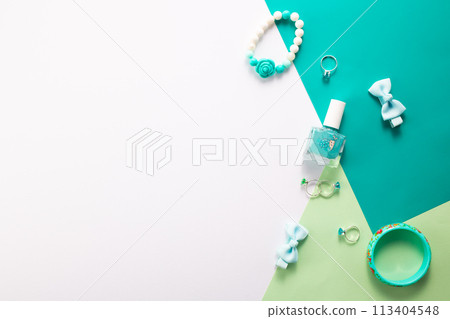 Little girls accessories on a white and green background, flat lay 113404548