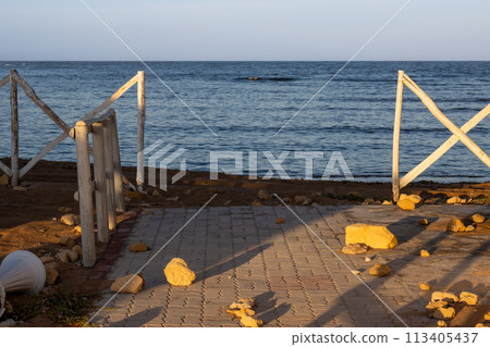 Seaside and a white fence in the morning sunlight, Sicily Seaside and a white fence in the morning sunlight, Sicily 113405437