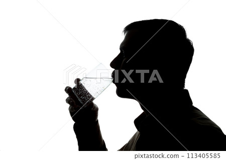 Young man drinks soda water - silhouette 113405585
