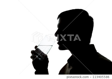 Young man drinks soda water - silhouette 113405586