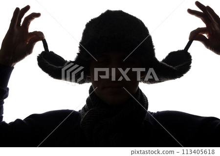 Young man in hat and gloves look ahead - horizontal silhouette Young man in hat and gloves look ahead - horizontal silhouette 113405618