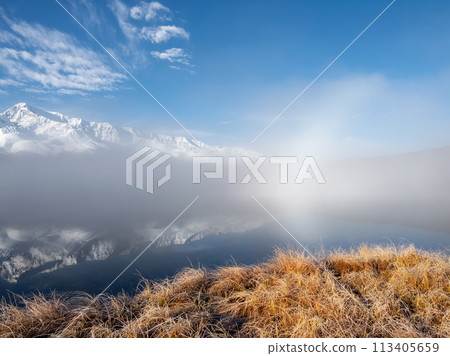 Sunrise on the mountain lake with fog. Sunrise on the mountain lake with fog. 113405659
