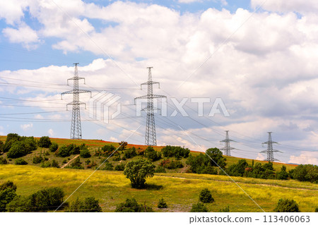 High voltage towers Electric pole. Power line support with wires for electricity transmission. High voltage grid tower with wire cable at distribution station. Energy industry, energy saving High voltage towers Electric pole. Power line support with wires for electricity transmission. High voltage grid tower with wire cable at distribution station. Energy industry, energy saving 113406063