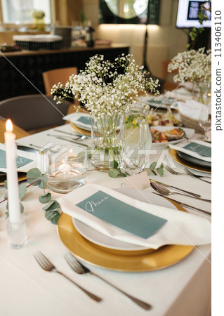 Beautiful and elegant wedding table in restaurant. Gypsophila and eucalyptus. Served table. 113406110