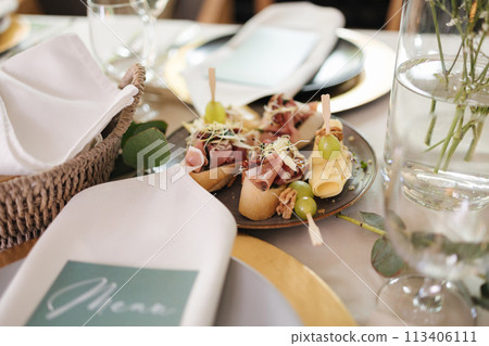 Close-up of table with food in restaurant. Fresh and healthy snack on plate. Served table 113406111