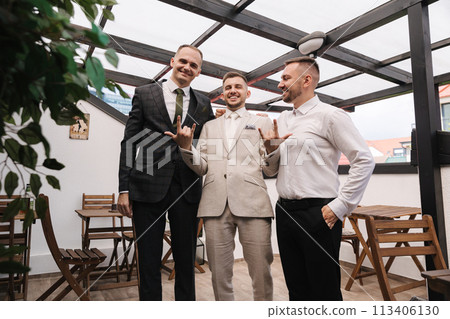 Portrait of tree stylish persons in suits have fun on terrace. Portrait of tree stylish persons in suits have fun on terrace. 113406130