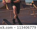 Skateboarder trains to perform stunts. High quality photo 113406779