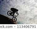 Silhouette of a young man engaged in extreme sports on a bicycle bike. High quality photo 113406791