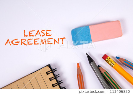 Lease Agreement. Colored pencils and eraser on a white table Lease Agreement. Colored pencils and eraser on a white table 113406820
