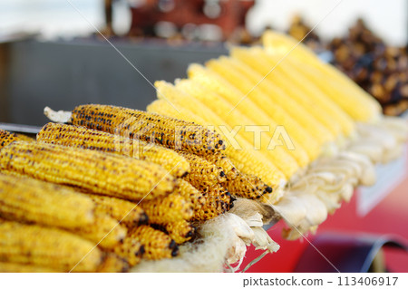 A typical street sale of boiled and grilled corn in Istanbul. Traditional Turkish fast food. National outdoor eat in Turkey. 113406917