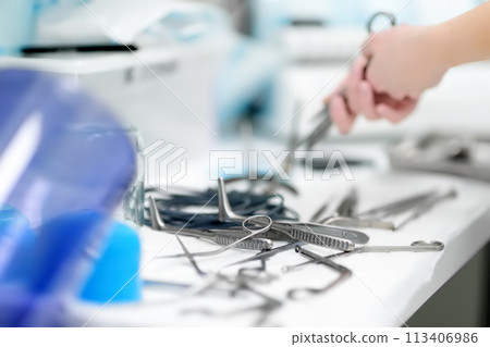 Nurse preparing surgical medical instruments for sterilizing after operation. Surgical tools kit. Nurse preparing surgical medical instruments for sterilizing after operation. Surgical tools kit. 113406986