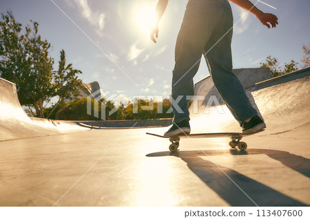Close up of young man doing tricks on his skateboard at the skate park. Active sport concept Close up of young man doing tricks on his skateboard at the skate park. Active sport concept 113407600
