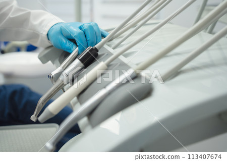 Woman smiling during her dental treatment at dentist. 113407674