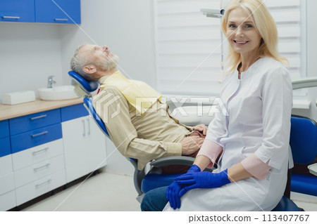 Male smiling during her dental treatment at dentist. 113407767