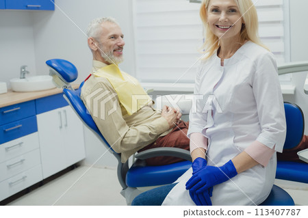 Male smiling during her dental treatment at dentist. 113407787