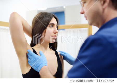 Doctor mammologist examines woman breasts and lymph nodes. Correcting the shape of the breast - lift, reduction, reconstruction, augmentation. Problems of lactation. Breast cancer. 113407896
