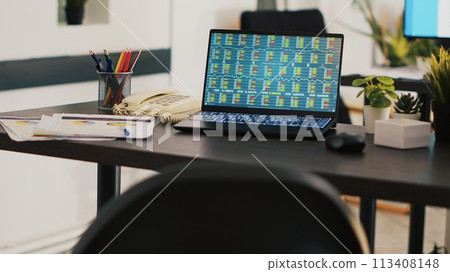 Company paperwork and laptop with stock market data collected in office to develop trading strategies. Business analytics files and notebook on desk in company workplace showing trading platform Company paperwork and laptop with stock market data collected in office to develop trading strategies. Business analytics files and notebook on desk in company workplace showing trading platform 113408148
