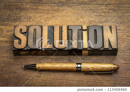 solution word abstract in vintage letterpress wood type against weathered wooden background, science, business and education concept 113408460