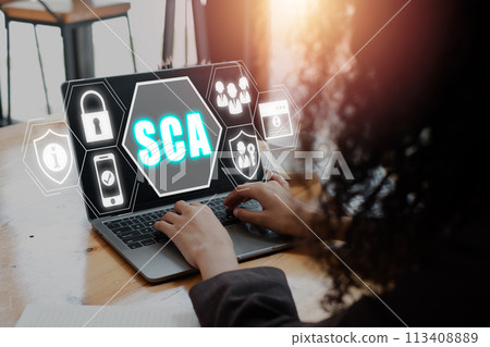 SCA, Strong customer authentication concept, Businesswoman using laptop computer on desk with strong customer authentication icon on virtual screen. 113408889