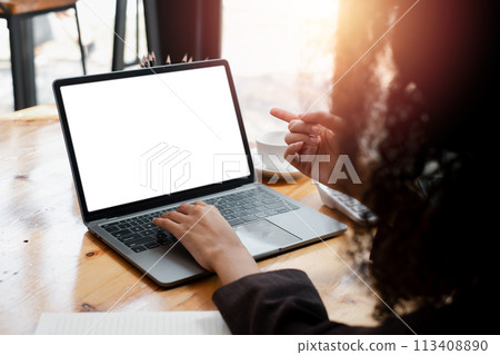 Close-up back view of a business woman working in the office typing, looking at the screen. office worker using a notebook computer. 113408890